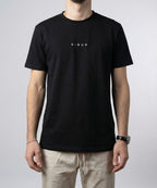 Close-up detail of DIBON black men’s t-shirt highlighting fabric texture and premium finish