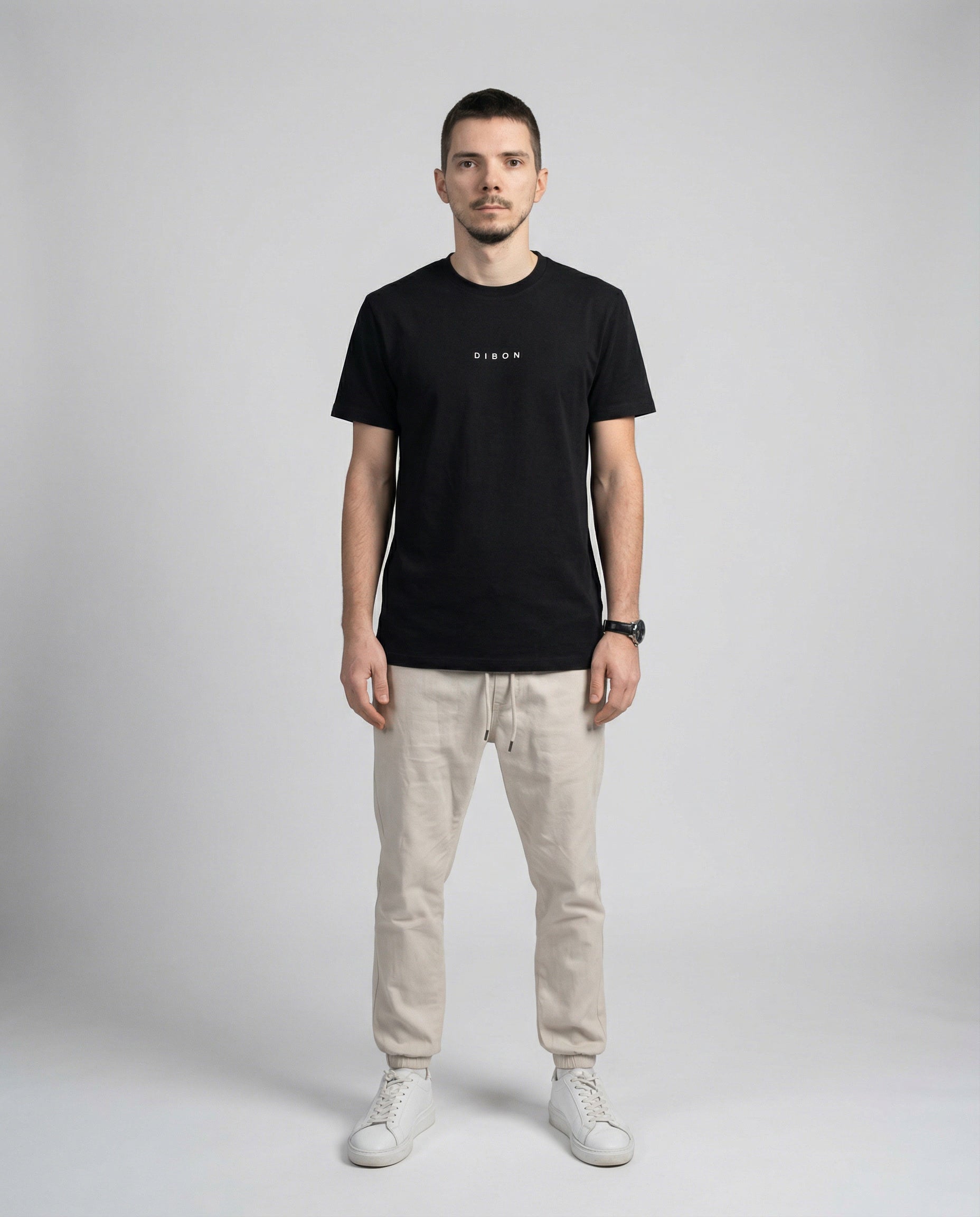 DIBON men’s black premium t-shirt with minimalist design, clean front view on model