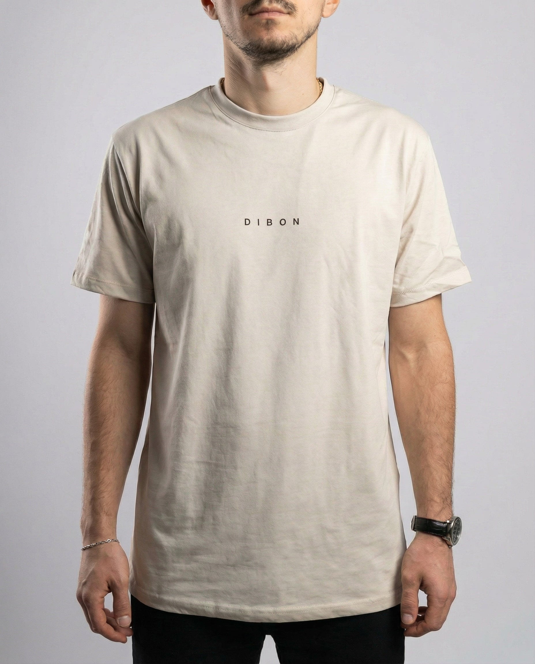 Close-up detail of DIBON cream men’s t-shirt showing fabric quality and fine finish